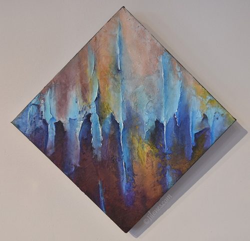 diamond shaped multicolored, sculpted abstract painting, featuring vertical lines, peaks and valleys