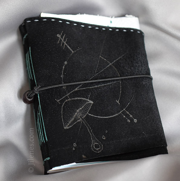 black leather journal with a mushroom & geometric design
